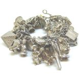 Sterling silver vintage charm bracelet full of assorted silver charms