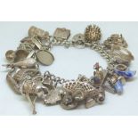 Silver charm bracelet with approximately 25 charms