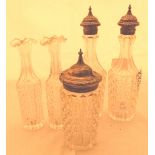 Three silver topped cut glass condiment bottles, assay Birmingham 1868, marked Elkington Bros,