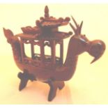 Oriental redwood carving of a boat modelled as a sea monster on a stand