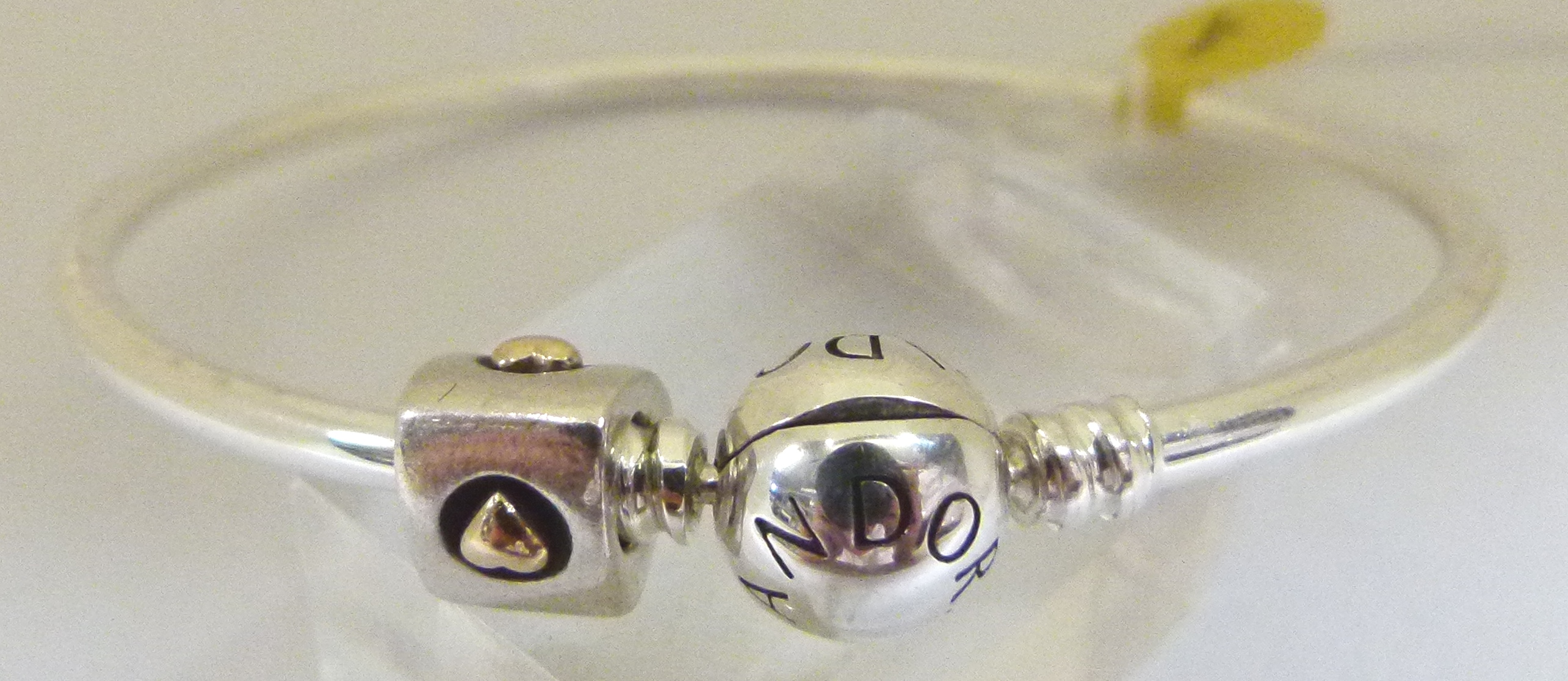 Sterling silver genuine Pandora bangle with a genuine Pandora silver and gold charm,