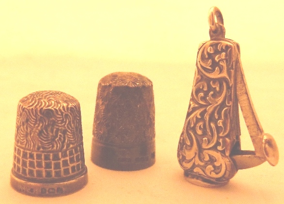 Two silver thimbles and a cheroot cutter