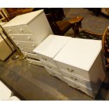 Pair of white bedside tables and a seven drawer chest