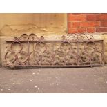 A length of decorative wrought iron balcony rails H: 40 W: 125 cm