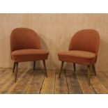 A pair of Mid Century German burnt orange upholstered cocktail chair with stained beech tapered