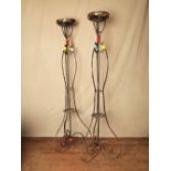 Late 20thC wrought iron Tiki style extra large candle lights with plastic coloured twine H: 189 W