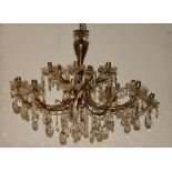 Victorian style brass and glass pendalogue chandelier coming with 12 arms and 18 candle cup lights