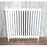 A restored 4 column cast iron radiator painted in white H: 91 W: 95 cm