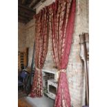 A pair of Victorian style burgundy and gold leaf patterned floor length curtains with matching gold