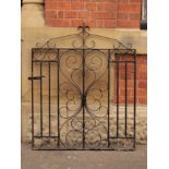 A wrought iron garden gate with decorative scrollwork H: 120 W: 92 cm
