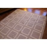 A contemporary woollen rug in light grey and cream rhythmic cube pattern 248 x 184 cm