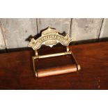 Victorian style brass and oak toilet roll holder embossed with 'Toilet Paper Fixture'