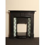 Victorian cast iron tiled combination fireplace with pale and dark green chequered tiles and floral
