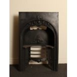 Early Victorian cast iron fire insert with decorative arch and raised grate