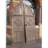 A pair of Victorian Gothic oak arched doors with wrought strap hinges H: 269 W: 162 cm