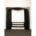 An early Victorian cast iron shaped top fireplace insert H: 82 W: 85