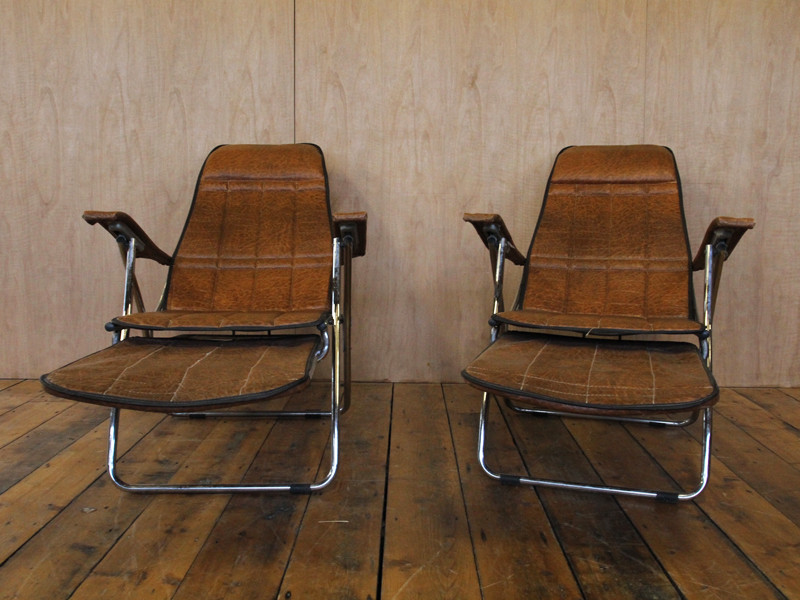 A pair of Mid Century crocodile skin patterned steel framed Italian deckchairs with extending and