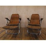 A pair of Mid Century crocodile skin patterned steel framed Italian deckchairs with extending and