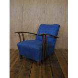 Art Deco electric blue upholstered deep cushioned armchair with beech wood frame.