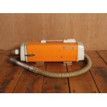 Retro compact Electra vacuum in bright orange H : 17 L : 60 W : 15 cm