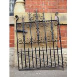 A Victorian wrought iron garden gate with decorative scrolls and spikes H:125 W: 87 cm