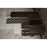 An assortment of cast iron grills and radiator sections