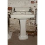 Art Deco style porcelain wash basin with simple chrome taps