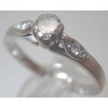 Solitaire diamond ring in 18ct white gold with three stones to each shoulder and a single stone