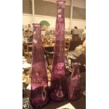 Three tall purple vases,