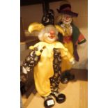 Two large ceramic and soft body clowns in clown dress clothing