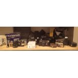 Shelf of assorted cameras including Olympus, Pentax,