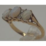 18 ct gold three stone opal and small diamond ring, size N, 3.