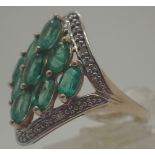 9 ct gold fancy nine stone emerald ring set with diamonds,