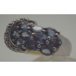 Sterling silver lilac stone set buckle ring, possibly tanzanite,