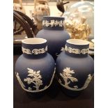 Three Wedgwood Royal Blue dipped jasperware vases, height of pair: 15 cm,