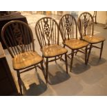 Four medium wood wheelback chairs