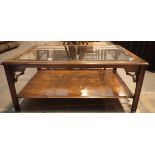 Glass topped large mahogany coffee table with under shelf