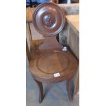 Dark oak hallway chair with rounded back and lion motif