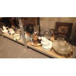 Two shelves of ceramics, pictures,