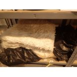 Bed throw cover and a sheepskin rug