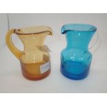 Two matching vintage Whitefriars cream jugs with polished pontil mark to base one amber colourway
