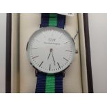 New and boxed white metal Daniel Wellington wristwatch on a fabric strap