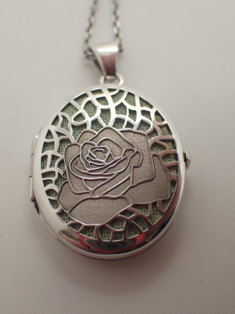 Silver locket with rose decoration on a silver chain