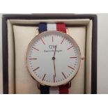 New and boxed yellow metal Daniel Wellington wristwatch on a fabric strap