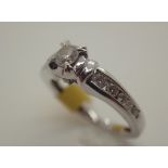 9ct white gold diamond solitaire ring with diamond set shoulders in original box,