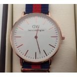 New and boxed yellow metal Daniel Wellington wristwatch on a fabric strap