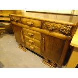 Good quality oak sideboard with three central drawers and carved detail