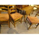 Circular dropleaf Ercol dining table with four matching chairs