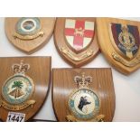 Five military insignia on wooden shields including Royal Army Medical Corps,