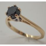 Black diamond solitaire ring in a white gold setting on a yellow gold shank size N approximately 0.